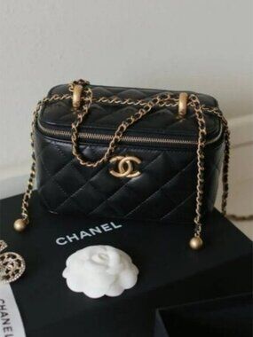 Chanel small black quilted lambskin chain cosmetic bag
